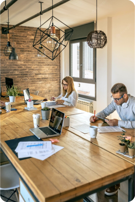 image showing a work bench at the offices in Buenos Aires where there's two people focused on their laptops